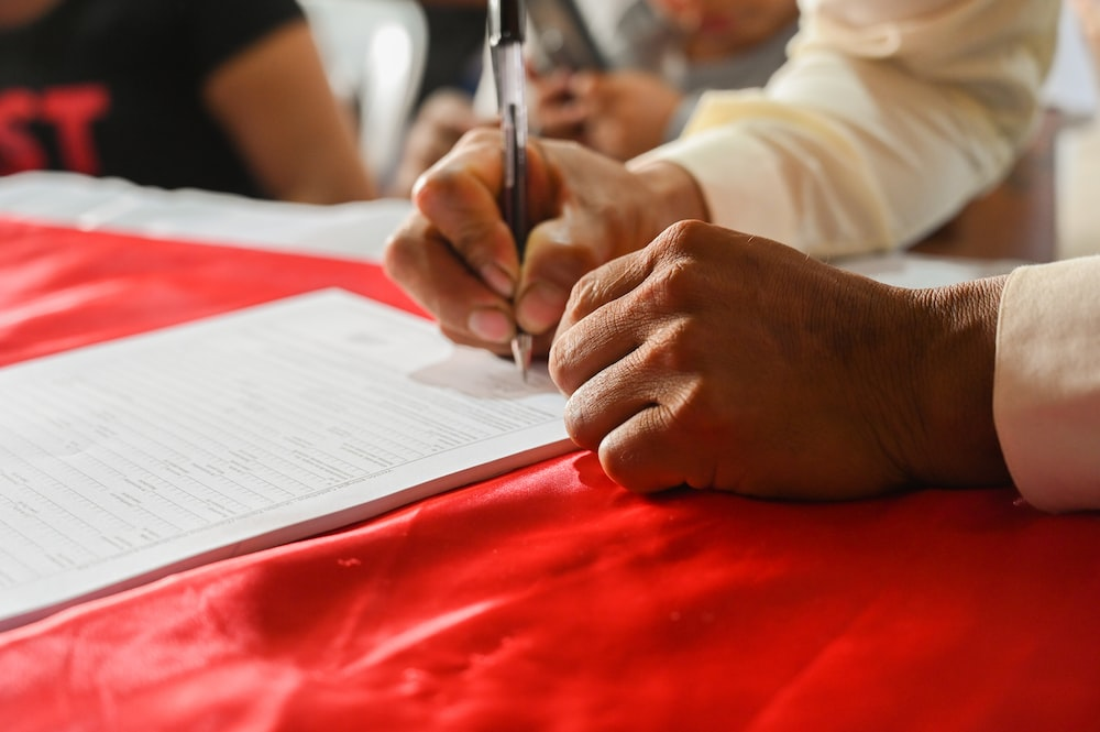 A Faceless Individual Signing an Employment Agreement