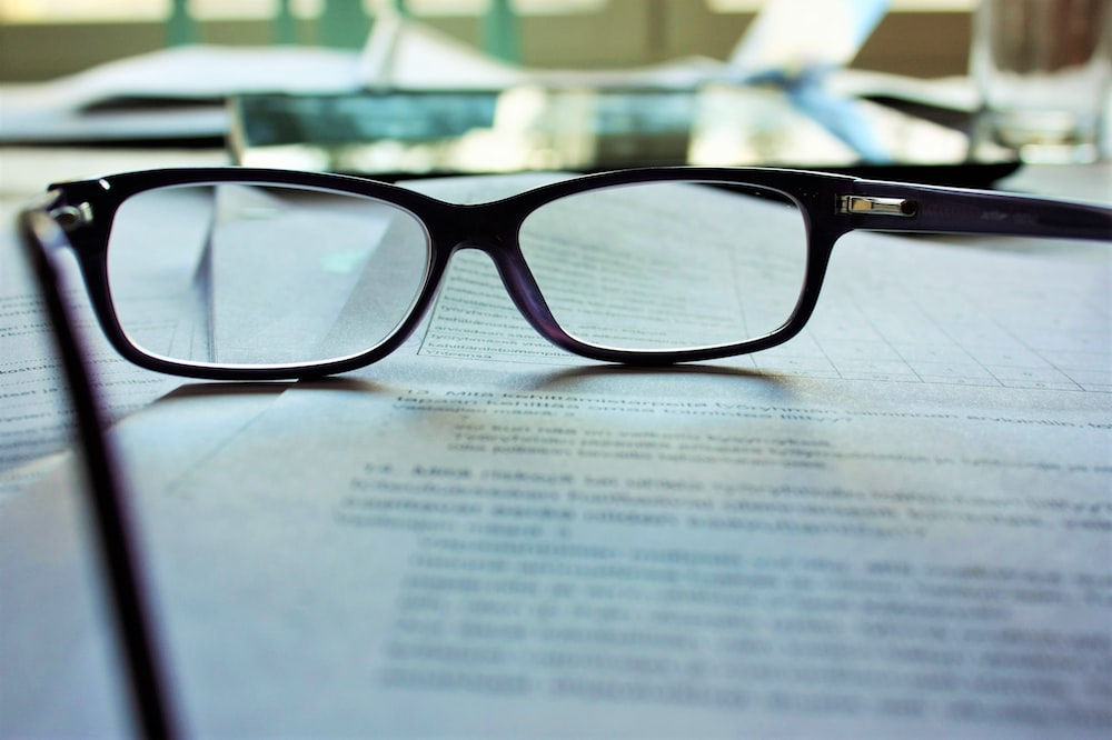 A Pair of Eyeglasses Sitting on a Bunch of Papers Featuring Non-Profit Bylaws