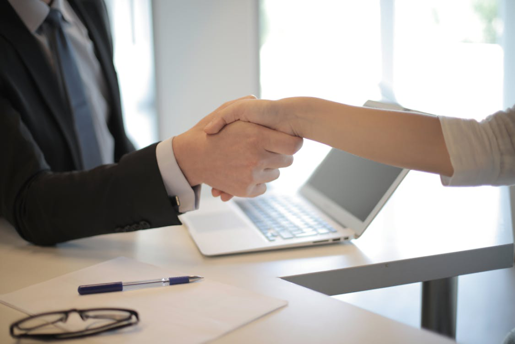 a person is shaking hands with a business attorney