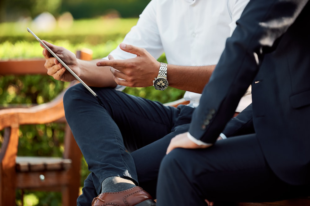 An image of two men looking at a tablet