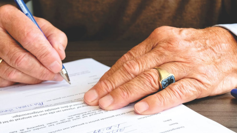 An image of a person signing an agreement   